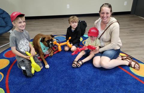 Family seated together with dog.