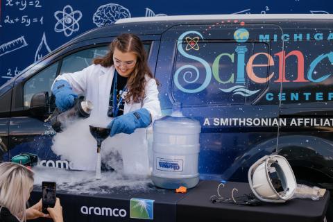 Female scientist pouring liquids in a container