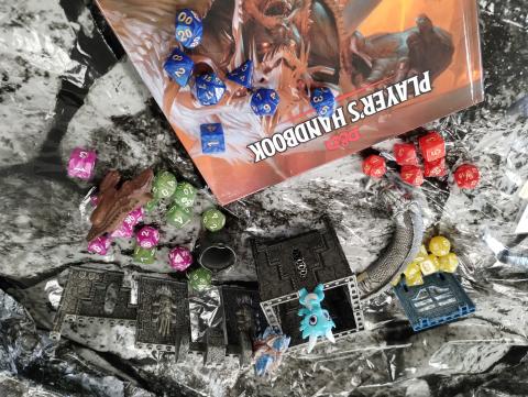 Dungeon and Dragons book with dice and characters