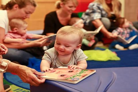 babies reading with parents