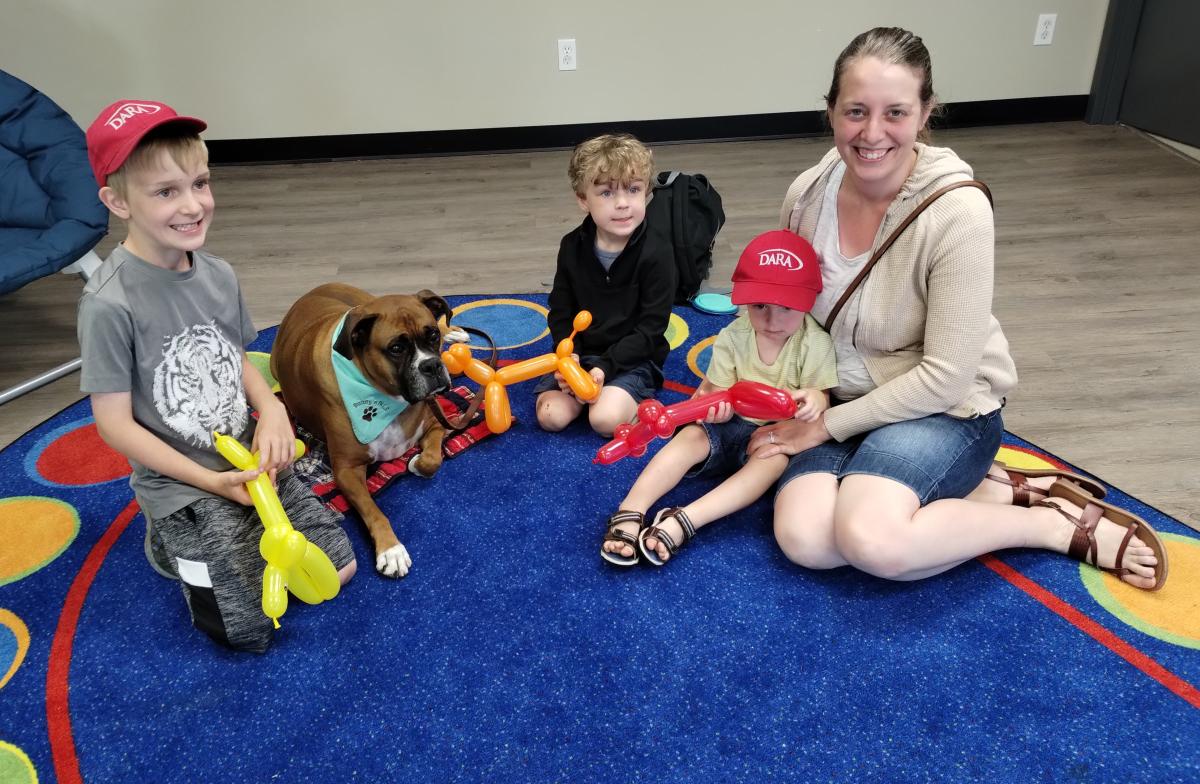 Family seated together with dog.