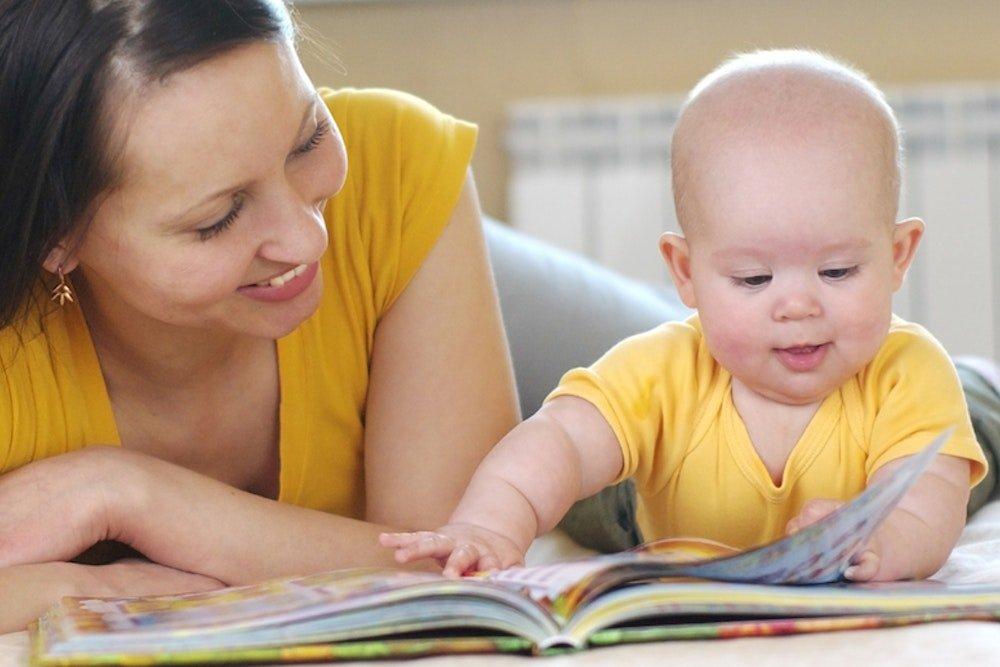 woman reading with a baby