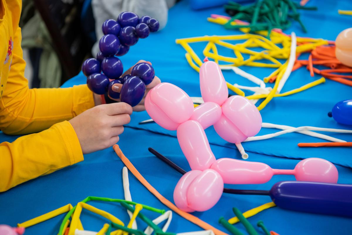 balloons on a table some twisted into shapes 