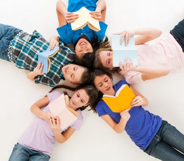 kids lying in a circle and reading 